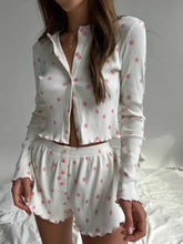 White ribbed knit top and shorts lounge set with pink floral print and ruffles