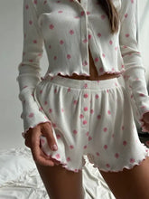 White ribbed pajama set with pink floral print and ruffled hems