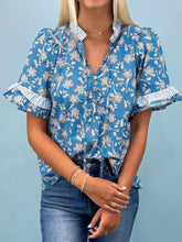 Blue floral print ruffle sleeve blouse with striped cuffs featuring ruffled short sleeves for a stylish look