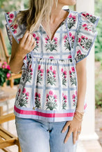Floral print ruffle sleeve blouse with pink flowers green stems on light blue grid and vibrant pink hem trim
