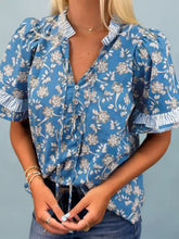 Blue floral print blouse with ruffled short sleeves and striped cuffs in lightweight fabric for casual wear