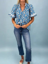 Blue floral print blouse with ruffled sleeves and button-down front perfect for casual and office wear