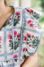 Floral print ruffle sleeve blouse with white base pink floral print blue grid lines and light blue ruffled trim