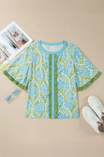 Floral print ruffled color block trim half sleeve blouse in light blue and green with ruffled neckline and sleeve hems