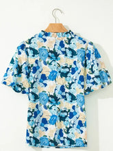 Blue and cream floral print blouse with ruffled neckline and short puff sleeve v neck design for stylish wear