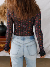 Black floral mesh long sleeve top with smocked cuff slim fit and ruffled cuffs in floral print design