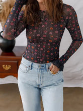 Sheer black floral print smocked cuff slim fit mesh bodysuit with long sleeves and ruffled cuffs