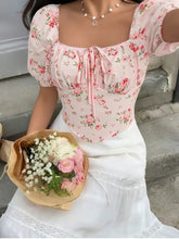 Pink floral corset top with puff sleeve design, square neckline, and front tie detail for a stylish look