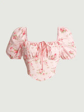 A delicate pink floral crop top with puff sleeve short sleeves and a tie front square neckline blouse