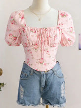 Pink floral print corset-style top with puff sleeve short sleeves and square neckline for stylish outfits