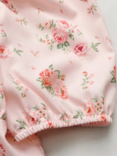 Pink floral print tie front puff sleeve blouse with delicate rose motifs and soft satin texture with elasticated hem