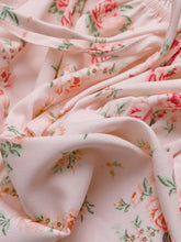 Soft pink floral print tie front puff sleeve blouse featuring coral and peach roses with green leaves on delicate fabric