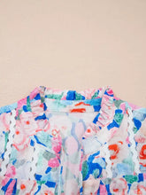 Floral print tie v neck blouse with ruffled collar and scalloped lace trim in soft pastel pink blue green and white