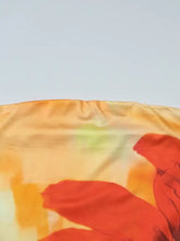 Floral print tube top made of soft silk with bold red poppy blossoms on a warm orange and yellow gradient background