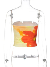 A vibrant orange poppy floral print tube top made of soft fabric with a strapless cropped design