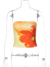 A vibrant orange floral print tube top made of soft sheer fabric featuring a strapless crop design