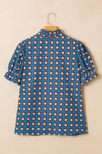 Blue puff sleeve blouse with geometric floral print in cream and dark brown featuring neck pleated ruffle detail