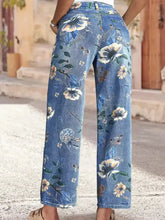 Blue denim jeans with wide leg cut and all-over floral print in white yellow and blue for a floral print wide look
