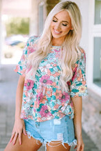 Woman in floral round neck babydoll top with short sleeve length and denim shorts
