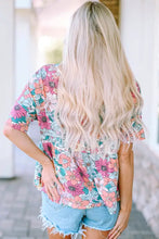 Woman in floral round neck babydoll top with short sleeve length