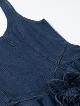 Floral ruffle layered denim dress in blue featuring a ruffled floral detail at the shoulder for a stylish look