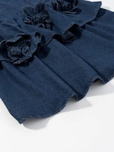 Denim skirt with ruffled dark blue fabric and decorative flower appliqués in a floral ruffle layered denim dress