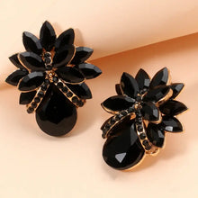 Black flower shape glass stone stud earrings with gold accents and rhinestones