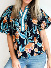 Black floral print blouse with short bubble sleeve and teal-trimmed notched neck collar for elegant wear