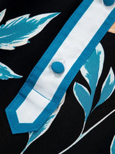 Black floral short bubble sleeve blouse with turquoise and white leaf pattern and notched neck placket trim