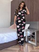 Black floral short sleeve shirt and pants lounge set with button-front design and pink and white floral pattern
