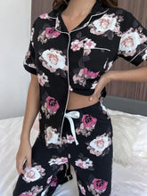 Black floral short sleeve shirt and pants lounge set with pink white rose print and contrasting white piping detailing