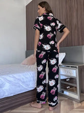 Black floral short sleeve shirt and pants lounge set with pink and white roses and rolled cuff pants for comfortable wear