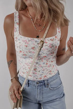 A floral textured square neck sleeveless bodysuit with delicate pastel floral print and thin straps
