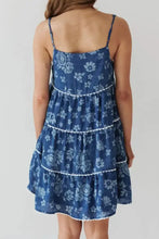 Blue floral denim dress with tiered square neck and delicate white lace trim along each tiered square layer