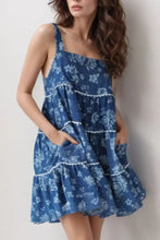 Blue floral print tiered square neck denim dress with white lace trim along the ruffled layers