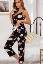 Black floral pajama set with pink and white rose print and tied waistband detail featuring adjustable strap length