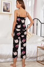 Black floral pajama set with pink and white roses on soft flowing fabric featuring adjustable strap length details