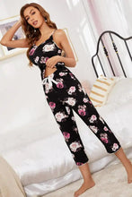 Black floral pajama set with pink and white rose print features a v-neck cami with adjustable strap length and cropped pants