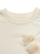 Cream-colored knit dropped shoulder sweatshirt with delicate sheer flower embellishments on the crewneck design