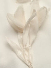 Delicate white silk flower petals with a soft sheen on a flower dropped shoulder sweatshirt in dropped shoulder style