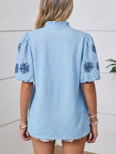 Light blue textured cotton blouse with flower embroidered puff sleeves and dark blue floral embroidery on shoulders