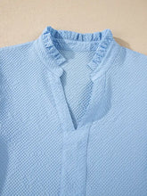 Light blue textured cotton flower embroidered puff sleeve blouse with ruffled collar and vertical seam detail