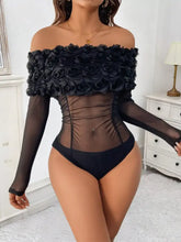 Black off-the-shoulder mesh bodysuit with floral ruffle detail and sheer mesh panels for elegant fashion