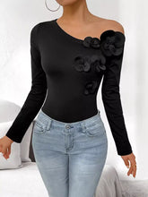 Black shoulder long sleeve bodysuit with off-the-shoulder design and layered floral appliqués on the shoulder