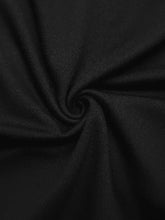 Black textured fabric with subtle woven pattern in flower one shoulder long sleeve bodysuit material close-up