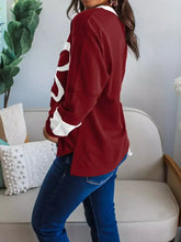 Maroon flower patched round neck long sleeve top with white lettering and cuffs suitable for machine wash cold