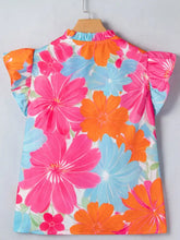 Flower printed sleeveless blouse with neck ruffle and vibrant pink orange and blue floral print on white fabric