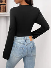 Black ribbed flower round neck long sleeve bodysuit made of soft material for stylish layering and comfort