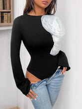 Black flower round neck long sleeve bodysuit with sheer white ruffled shoulder embellishment and flared cuffs
