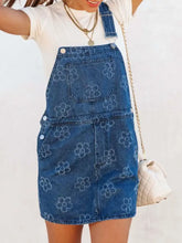 Flower wide strap denim overall dress in blue denim with subtle white floral pattern and front pockets machine wash cold